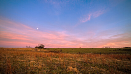 Fototapeta na wymiar Winter field at sunset but looking east