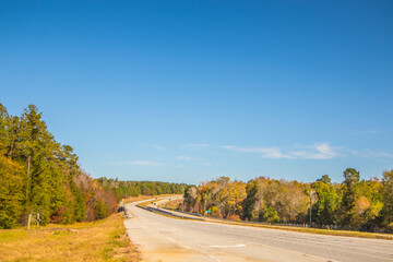 A long highway in the country during the Fall in Georgia light traffic