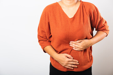 Asian woman she sick have stomach ache holds hands on abdomen, part of body, female having painful stomachache she abdomen bloating or chronic gastritis, studio shot isolated on white background