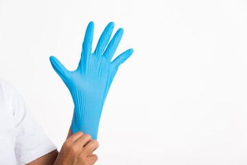 Woman wearing and putting hand to blue rubber latex glove for doctor, studio shot isolated on white background, Hospital medical safety concept
