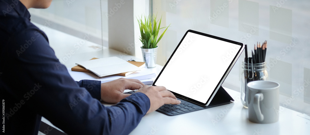 Poster business man working on computer tablet at his workspace. blank screen for graphics display montage.