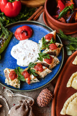 Muslim Ramadan iftar family dinner. Flat-lay of people feasting over table with Middle East food. Dates, dolma, kebab, flatbread, pide, borek, sweet, salad, top view. Ramazan fasting Turkish cuisine.