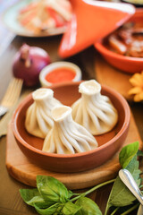 Georgian dumplings Khinkali with meat on metal plate close-up