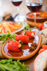 Muslim Ramadan iftar family dinner. Flat-lay of people feasting over table with Middle East food. Dates, dolma, kebab, flatbread, pide, borek, sweet, salad, top view. Ramazan fasting Turkish cuisine.