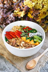 Selective focus for green Smoothie bowls  from Green tea and Spinach with fruits, nuts, seeds and homemade granola and strawberry for healthy vegetarian.
