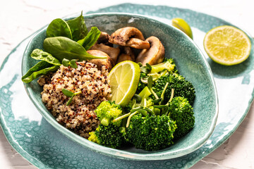 Green vegetable vegan salad with spinach, mushrooms and broccoli and quinoa. Healthy vegetarian food concept. top view