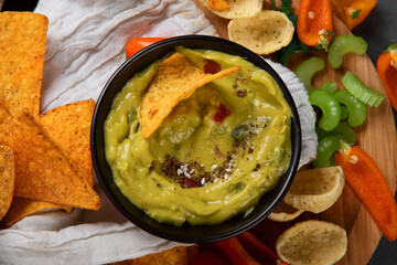 Different kinds of hummus dips with snacks