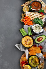 Different kinds of hummus dips with snacks