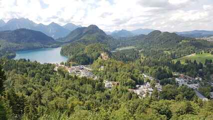 Fototapeta na wymiar Hohenschwangau castle from a height against the background of mountains and sky in bavaria