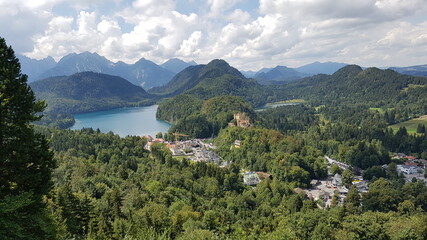 Fototapeta na wymiar Hohenschwangau castle from a height against the background of mountains and sky in bavaria