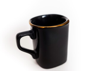 Black purchased earthenware coffee Cup close up on white background