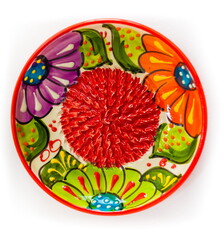 Colored decorative ceramic plate with closeup pattern on white background