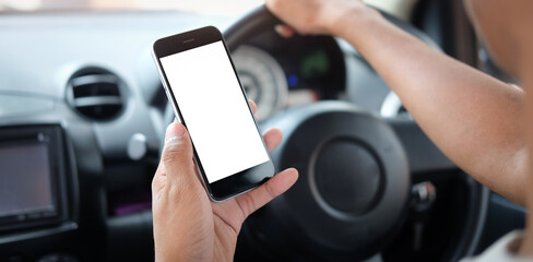 Closeup image man driver using smartphone with white screen while driving a car.