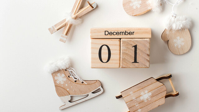Wooden calendar for December 1 and toy skis. Concept of the beginning of winter, opening of the ski season. Copy space.