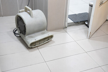 Floor dryer blower fan machine in bathroom drying wet floor