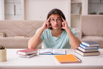 Young male student preparing for exams at home