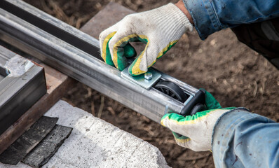 The worker installs the rollers on the sliding gates.
