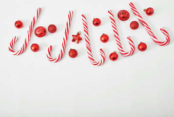 Christmas lollipops and toys background. Xmas flat lay. Happy New Year and Merry Christmas greeting card. Template, copy space. Winter celebrations, weekends and vacations