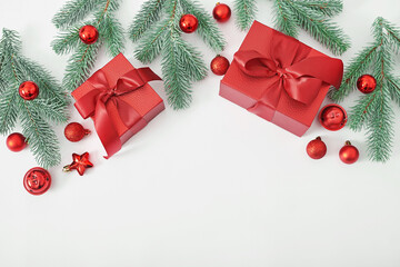 Christmas gift box, pine branches and toys background. Xmas flat lay. Happy New Year and Merry Christmas greeting card. Template, copy space. Winter celebrations, weekends and vacations.