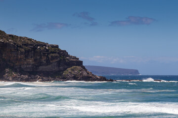 Palm Beach, in Sydney's north shore, with ocean views and cliffs in the distance,on a clear, sunny day