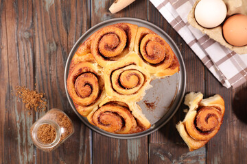 cinnamon roll on wood background