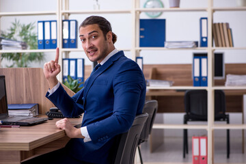 Young male employee working in the office