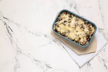 Baking dish with tasty rice casserole on white background
