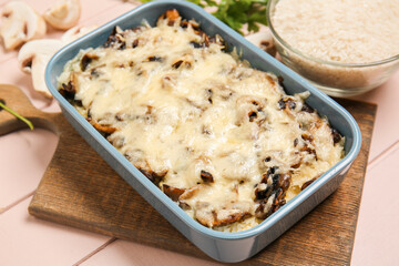 Baking dish with tasty rice casserole on table
