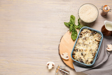 Baking dish with tasty rice casserole on table