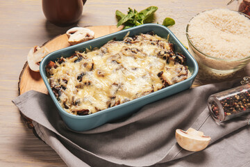 Baking dish with tasty rice casserole on table