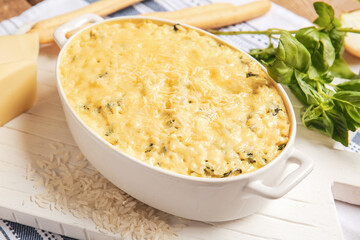 Baking dish with tasty rice casserole on table
