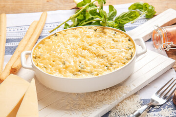 Baking dish with tasty rice casserole on table