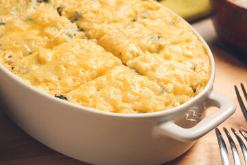 Baking dish with tasty rice casserole on table, closeup