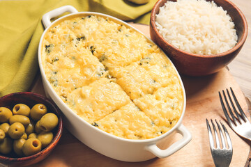 Baking dish with tasty rice casserole on table