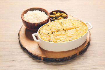 Baking dish with tasty rice casserole on table