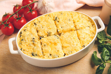 Baking dish with tasty rice casserole on table