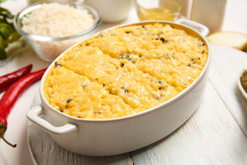 Baking dish with tasty rice casserole on table