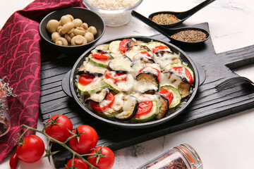 Baking dish with tasty rice casserole on table