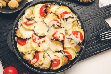 Baking dish with tasty rice casserole on table
