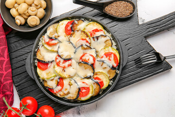 Baking dish with tasty rice casserole on table