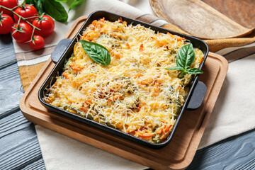 Baking dish with tasty rice casserole on table