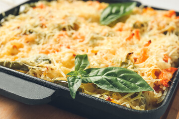 Baking dish with tasty rice casserole on table, closeup