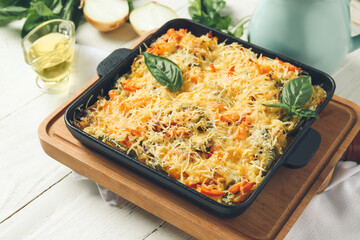 Baking dish with tasty rice casserole on table