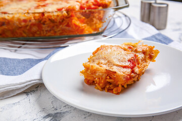 Plate with tasty rice casserole on table, closeup