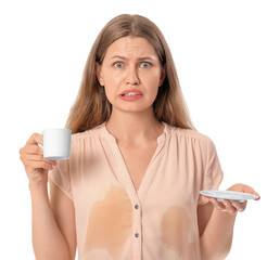 Stressed young woman with coffee stains on her shirt on white background