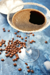 Glass of tasty espresso martini cocktail on color background