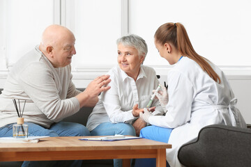 Doctor visiting senior diabetic couple at home