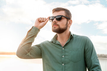 Handsome man with stylish sunglasses outdoors