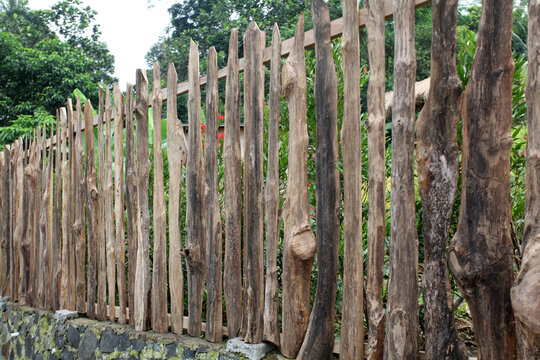 Fence built from wood. Close up of wooden fence. House fence made of wood.