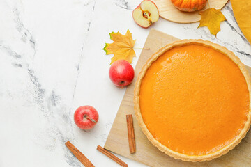 Composition with tasty pumpkin pie on light background